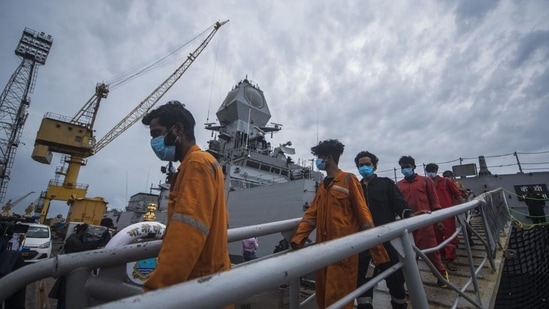Crew members of ONGC's Barge P305 who were stranded in the Mumbai offshore due to Cyclone Tauktae, coming out of INS Kochi after they were rescued by the Indian Navy, at Naval Dockyard, in Mumbai on Wednesday, May 19. (Pratik Chorge/HT photo) Crew members of ONGC's Barge P305 who were stranded in the Mumbai offshore due to Cyclone Tauktae, coming out of INS Kochi after they were rescued by the Indian Navy, at Naval Dockyard, in Mumbai on Wednesday, May 19. (Pratik Chorge/HT photo)