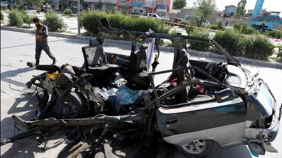 A police officer inspects a damaged van after a blast in Kabul, Afghanistan, on Thursday. (REUTERS) A police officer inspects a damaged van after a blast in Kabul, Afghanistan, on Thursday. (REUTERS)