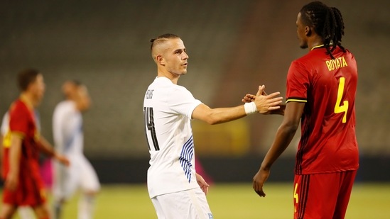 Greece's Dimitris Pelkas, center, shakes hands with Belgium's Dedryck Boyata.(AP) Greece's Dimitris Pelkas, center, shakes hands with Belgium's Dedryck Boyata.(AP)
