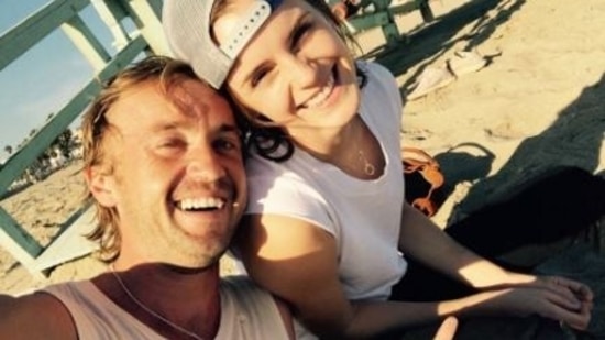 Tom Felton and Emma Watson pose together.