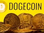 Cryptocurrency representations are seen in front of the Dogecoin logo in this illustration picture taken on April 20, 2021. 
