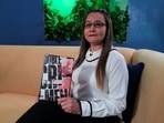 Linda Lopez holds her book "Double Crime" which she signs with her middle name Loaiza in Caracas, Venezuela.
