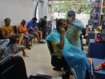 People having a haircut in a salon on Ghodbunder in Maharashtra. (Praful Gangurde / HT Photo)
