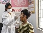 A health worker in PPE coveralls collects a swab sample from a factory worker for Covid-19 test, at Naraina, in New Delhi. (Sanchit Khanna/ Hindustan Times) A health worker in PPE coveralls collects a swab sample from a factory worker for Covid-19 test, at Naraina, in New Delhi. (Sanchit Khanna/ Hindustan Times)
