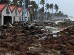 People walk through a damaged shoreline after Cyclone Yaas hit India's eastern coast in the Bay of Bengal, at a beach in Shankarpur, some 180 km from Kolkata on May 27. People walk through a damaged shoreline after Cyclone Yaas hit India's eastern coast in the Bay of Bengal, at a beach in Shankarpur, some 180 km from Kolkata on May 27.