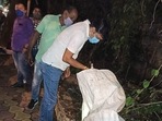 Police officials look into a sack filled with crude bombs. (ANI) Police officials look into a sack filled with crude bombs. (ANI)