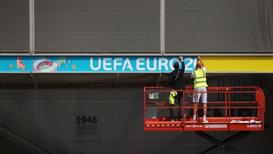 Workers attach Euro 2020 signage to Wembley Stadium. (Action Images via Reuters)