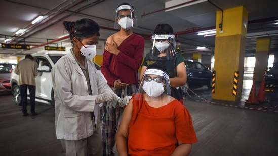 A health worker administering a dose of Covid-19 vaccine at a drive-thru camp at Unity Mall in Rohini, New Delhi on June 3. The city's healthcare infrastructure and crematoriums were hugely overburdened during the second wave of Covid-19. The situation has, however, improved significantly. The positivity rate in Delhi has now come down to below one per cent. (Sanchit Khanna / HT Photo) A health worker administering a dose of Covid-19 vaccine at a drive-thru camp at Unity Mall in Rohini, New Delhi on June 3. The city's healthcare infrastructure and crematoriums were hugely overburdened during the second wave of Covid-19. The situation has, however, improved significantly. The positivity rate in Delhi has now come down to below one per cent. (Sanchit Khanna / HT Photo)