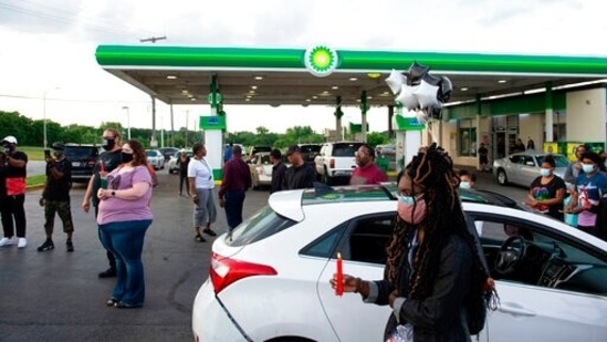 People gather for a vigil at the BP gas station in Kansas City, Missouri, Wednesday where Malcolm Johnson was shot and killed by police.(AP) People gather for a vigil at the BP gas station in Kansas City, Missouri, Wednesday where Malcolm Johnson was shot and killed by police.(AP)