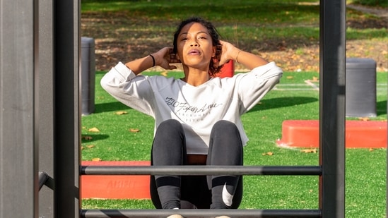 Crunches: One of the most effective ways of burning stomach fat is by practising crunches. Lay flat on your back with your knees up and feet on the ground. Place your arms across your chest, contract your abs as you inhale.(Unsplash)