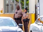 Miami-Dade Police officers are shown outside a Shell gas station near the scene of a shooting in Miami, Florida. Miami-Dade Police officers are shown outside a Shell gas station near the scene of a shooting in Miami, Florida.