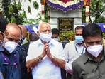 Karnataka chief minister B S Yediyurappa greets people after he pays respect to former CM D Devaraj Urs on his death anniversary in Bengaluru.  