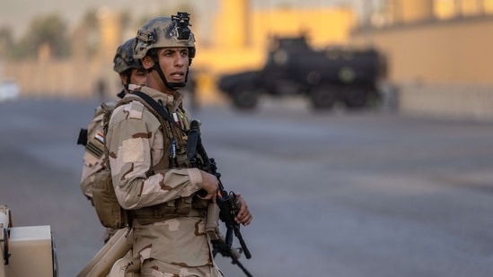 Iraqi Army soldiers stand guard on a road between the US Embassy and the International Zone. (AFP) Iraqi Army soldiers stand guard on a road between the US Embassy and the International Zone. (AFP)