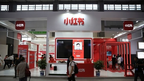 A man walks past the booth of Chinese startup Xiaohongshu, which means "little red book" in Chinese, in Guiyang, Guizhou province, China. (Reuters / file)