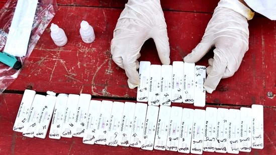 A healthcare worker shows a Covid sample kit after collecting samples in Mumbai.(ANI File Photo) A healthcare worker shows a Covid sample kit after collecting samples in Mumbai.(ANI File Photo)