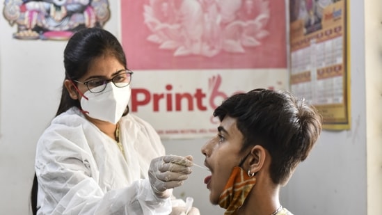 A health worker in PPE coveralls collects a swab sample from a factory worker for Covid-19 test, at Naraina, in New Delhi. (Sanchit Khanna/ HT Photo) A health worker in PPE coveralls collects a swab sample from a factory worker for Covid-19 test, at Naraina, in New Delhi. (Sanchit Khanna/ HT Photo)