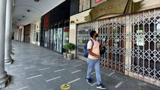 A man walking past a closed bakery in Connaught Place during a Covid-19 induced lockdown, in New Delhi on June 5. Several states have begun easing lockdowns and other curbs since the beginning of June after cases vegan coming down from the peak of the second wave. (Sanjeev Verma / HT Photo)
