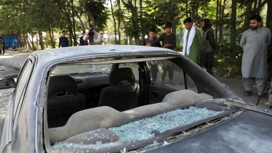 Afghan men look at a damage car after a roadside bomb explosion in Kabul, Afghanistan, Sunday. (AP) Afghan men look at a damage car after a roadside bomb explosion in Kabul, Afghanistan, Sunday. (AP)