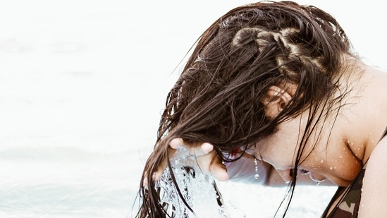 Wash hair with mild shampoo: Your hair can get very sweaty and sticky after your workout. Use a mild everyday shampoo and massage it only on the scalp and rinse. If you do not want to wash your hair every day then just leave your hair open and let it air dry.(Unsplash)