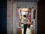 A shopkeeper opens his store in a market area after authorities eased Covid-19 lockdown restrictions that were imposed to slow down the spread of the coronavirus in New Delhi on June 7. Several parts of the country resumed activities on June 7 as part of the gradual easing of a lockdown that had been imposed two months ago to check the second wave of infections.