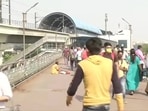 People near the Anand Vihar metro station on Monday morning. People near the Anand Vihar metro station on Monday morning.