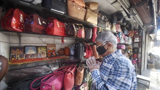 A shopkeeper was seen offering prayers as he reopened his shop at the Karolbagh market.(PTI)