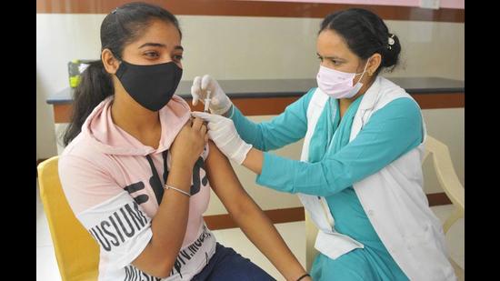 A young woman getting vaccinated at a camp organised by the Market Welfare Association, Sector 44-D, at Sood Bhawan, Sector 44, in Chandigarh on Monday. (Keshav Singh/HT)