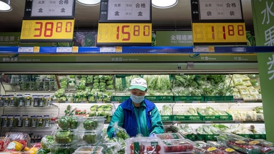 An employee sorts vegetables inside a Metro China supermarket, operated by Wumei Technology Group Inc., in Beijing, China. (Bloomberg) An employee sorts vegetables inside a Metro China supermarket, operated by Wumei Technology Group Inc., in Beijing, China. (Bloomberg)