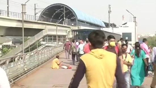 People near the Anand Vihar metro station on Monday morning.(ANI Photo)