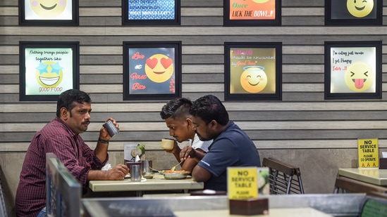 People eating in a restaurant after the unlock process began, at Sion in Mumbai on June 7. The Brihanmumbai Municipal Corporation (BMC) appealed to citizens not to let their guard down and follow all precautions to check the spread of Covid-19. (Kunal Patil / PTI) People eating in a restaurant after the unlock process began, at Sion in Mumbai on June 7. The Brihanmumbai Municipal Corporation (BMC) appealed to citizens not to let their guard down and follow all precautions to check the spread of Covid-19. (Kunal Patil / PTI)