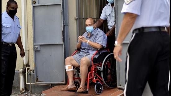 Mehul Choksi exits in a wheelchair the magistrate's court in Roseau, Dominica, Friday, June 4. (AP)