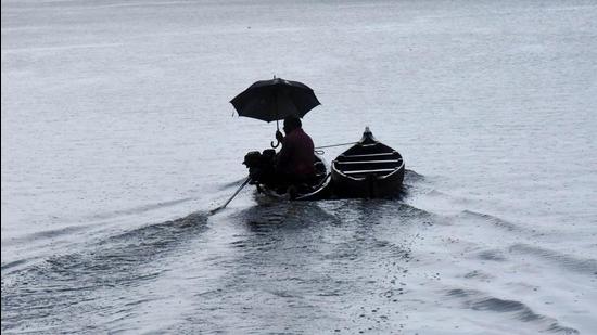 A man holds an umbrella as he rows a boat during rain after monsoon made a landfall in Kerala on Friday, June 4. (PTI) A man holds an umbrella as he rows a boat during rain after monsoon made a landfall in Kerala on Friday, June 4. (PTI)