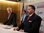 US Embassy's FBI Legal Attache Anthony Russo speaks as Australian Prime Minister Scott Morrison looks on during a media briefing.
