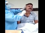 The image shows a healthcare worker shaving the beard of a Covid patient in Odisha.(ANI) The image shows a healthcare worker shaving the beard of a Covid patient in Odisha.(ANI)