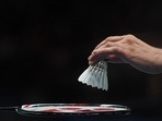 A match official places a new shuttlecock on a racket.(Getty Images)