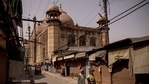 Pedestrians walk past closed stores in a deserted market area during lockdown restrictions in Agra, on Sunday.(Bloomberg Photo) Pedestrians walk past closed stores in a deserted market area during lockdown restrictions in Agra, on Sunday.(Bloomberg Photo)