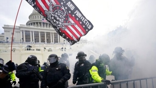 US Capitol Police officers hold off rioters loyal to President Donald Trump at the Capitol in Washington.(AP / File)