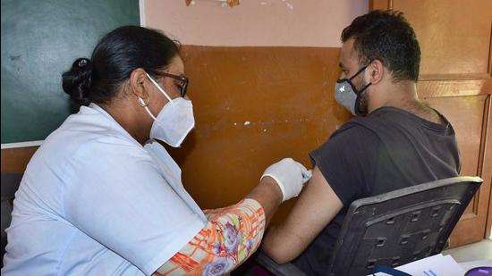 A medic administers a Covid vaccine dose to a man in Ludhiana on Tuesday. (Harsimar Pal Singh/HT)