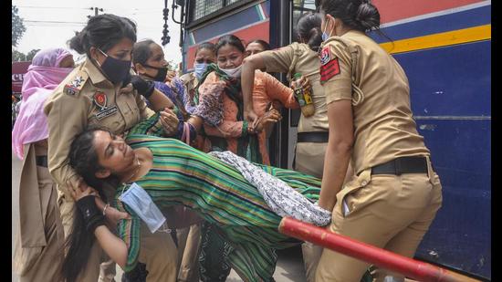 Police personnel detain a protester in Patiala on Tuesday. (PTI)