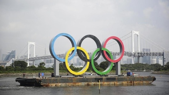 File photo, the Olympic rings for the Olympic and Paralympic Games Tokyo 2020 pass by on a barge by tugboats off the Odaiba Marine Park in Tokyo.(AP)