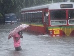 A man makes his way across a flooded street during heavy rains in Mumbai, on June 9. The southwest monsoon arrived in Mumbai on June 9 morning, with most parts of the city receiving intense showers as early as 4am, HT reported.