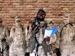 Boko Haram leader Abubakar Shekau speaks in front of guards in an unknown location in Nigeria in this still image taken from an undated video.