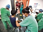 Healthworkers vaccinate a beneficiary at a hospital in Delhi(HT Photo)