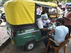 Health workers administer Covid-19 vaccine doses to auto-rickshaw drivers outside the railway station in Ranchi. 