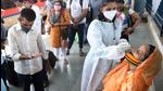 A BMC healthcare worker collects swab samples for Covid-19 test of passengers arriving at Dadar station in Mumbai on June 4. (Satish Bate/HT photo) A BMC healthcare worker collects swab samples for Covid-19 test of passengers arriving at Dadar station in Mumbai on June 4. (Satish Bate/HT photo)