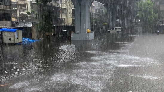 A man takes shelter under a bridge during heavy rains in Mumbai, on June 9. According to the India Meteorological Department’s (IMD) automatic weather station in Santacruz, 59.6mm of rainfall was recorded in the 24 hours ending 8:30am on June 9, while Colaba reported 77mm of rainfall during that period.(Rafiq Maqbool / AP)