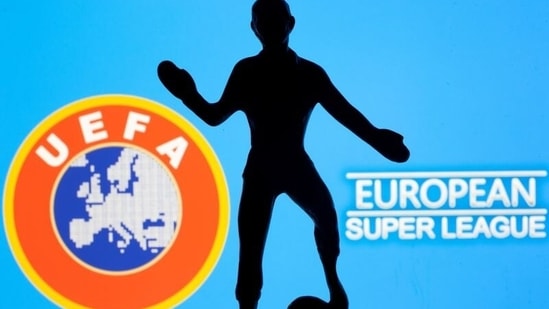 FILE PHOTO: A metal figure of a football player with a ball is seen in front of the words "European Super League" and the UEFA logo in this illustration taken April 20, 2021. (REUTERS)