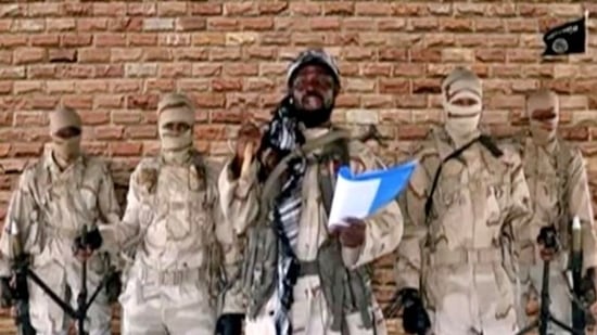 Boko Haram leader Abubakar Shekau speaks in front of guards in an unknown location in Nigeria in this still image taken from an undated video.(Reuters)