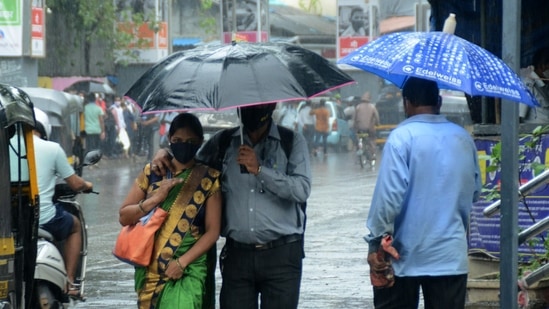 A couple walks under an umbrella at Andheri during heavy rainfall in Mumbai, on June 8. Mumbai has so far received 185mm of cumulative rainfall in June, HT reported.(Vijay Bate / HT Photo)