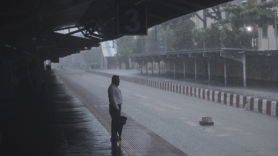 A man waits next to flooded railway tracks in Mumbai, on June 9. “The southwest monsoon has come in two days earlier than usual this year, as predicted by the meteorology department. There will be intense rains in Mumbai for at least a period of three to four days now, during which the total reading is quite likely to exceed 300mm, or even 350mm,” a spokesperson with the IMD’s regional forecasting centre in Mumbai told HT.(Rafiq Maqbool / AP)